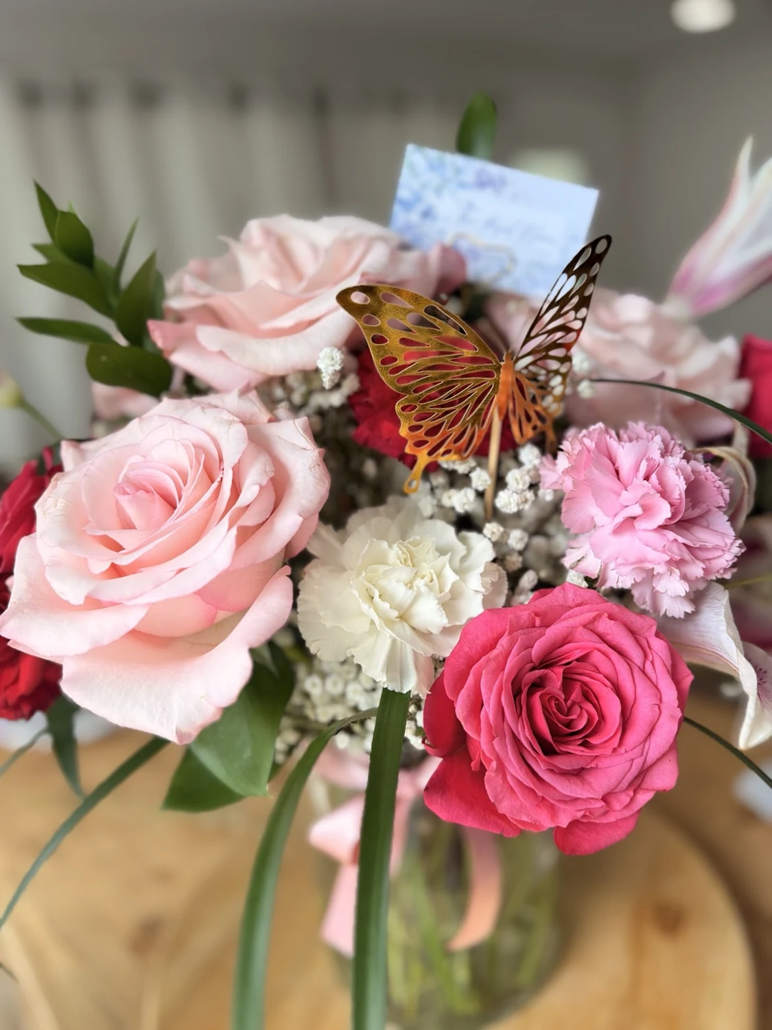 Pink roses and hydrangea with a butterfly detail